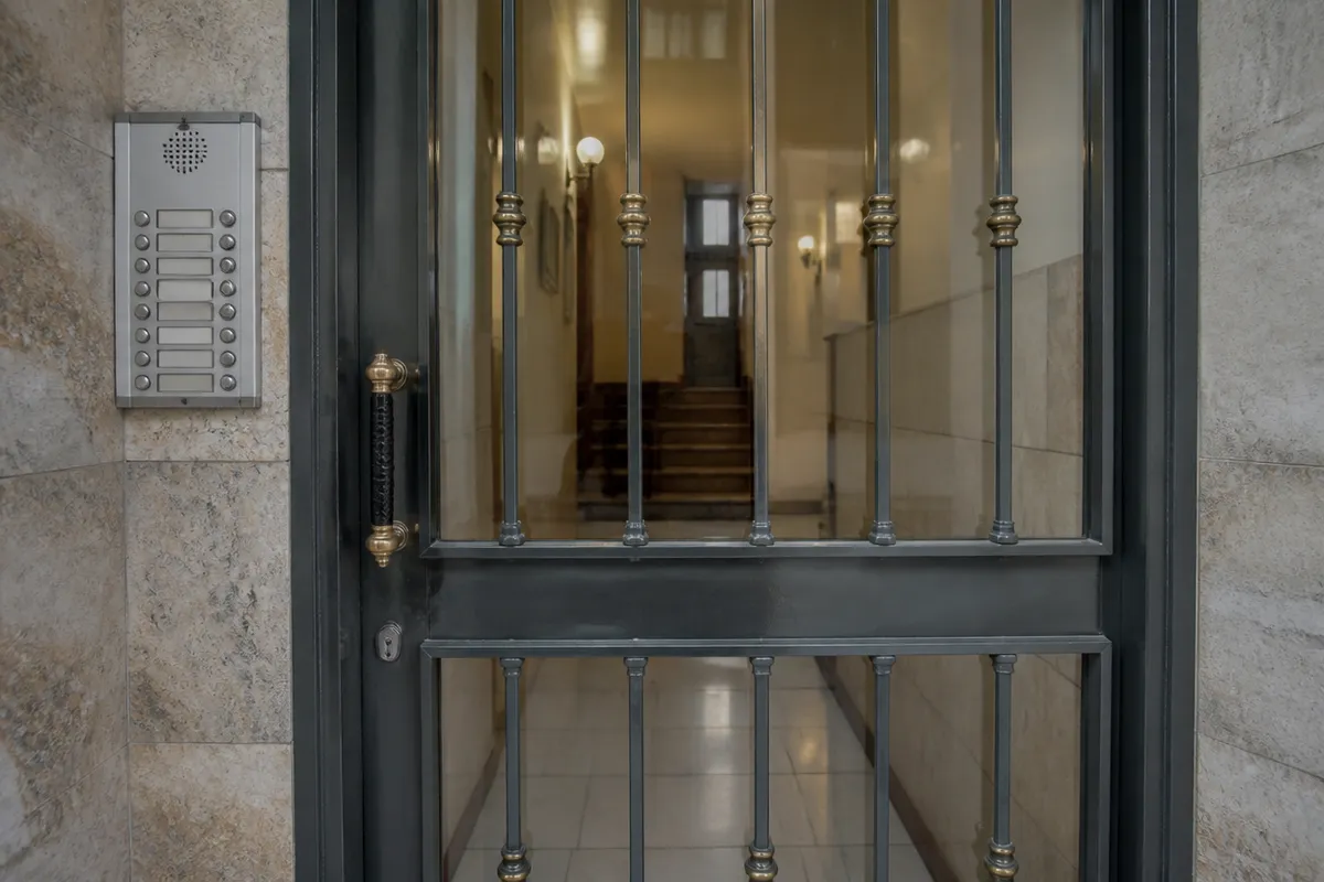 Metal community entrance in Barcelona with an intercom, locksmith work for businesses